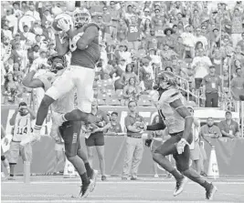  ?? CHARLES TRAINOR JR./MIAMI HERALD ?? Miami Hurricanes Dayall Harris (80) catches a third-quarter touchdown against the Toledo Rockets at Hard Rock Stadium on Saturday.