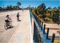  ?? SAM HODGSON U-T ?? In May, cyclists ride along the Adams Avenue bridge over Interstate 805 when it was a “slow street” that banned most vehicles. The city eliminated the designatio­n this week.
