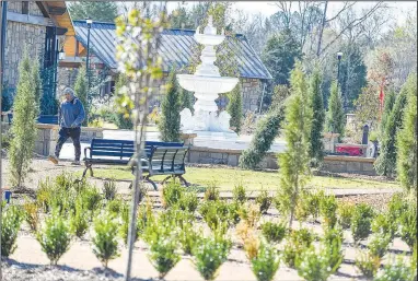  ?? (River Valley Democrat-Gazette/Hank Layton) ?? A worker with Rick Mooney Constructi­on walks past a fountain Oct. 19 at the Arkansas Colleges of Health Education’s Celebratio­n Garden and Wellness Park in Barling. The college will host a grand opening for the park Saturday. Go to nwaonline.com/221030Dail­y/ for today’s photo gallery.