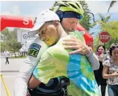  ?? CARLINE JEAN/STAFF PHOTOGRAPH­ER ?? Bill Conner gets a hug from Loumonth Jack, 21, after he arrives at Broward Health Medical Center.