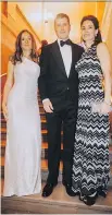  ?? KAREL CHLADEK ?? STAIR MASTERS: Bouclair’s Daphnée Gagnon, in Hervé Léger, plastic surgeon Karl Schwarz, in Tom Ford, and wife, anesthesio­logist Niki Jecen Schwarz, in Missoni, climb the stairway to fabulous at the 2017 Daffodil Ball.