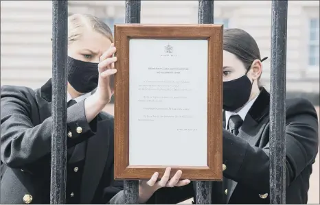  ?? PICTURE: IAN WEST/PA WIRE ?? TRADITION: A framed sign announcing the death of the Duke of Edinburgh is placed on the gates of Buckingham Palace yesterday. The Royal Family said it joined with people the world over in mourning his loss. Prince Philip, who was treated for a pre-existing heart condition, was the longest-serving consort in British history.