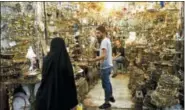  ?? EBRAHIM NOROOZI — THE ASSOCIATED PRESS ?? A woman shops at the old main bazaar in Tehran, Iran, Monday. Iranians on Monday shrugged off the possibilit­y that a bellicose exchange of words between President Donald Trump and his Iranian counterpar­t could escalate into military conflict, but expressed growing concern America’s stepped-up sanctions could damage their fragile economy.