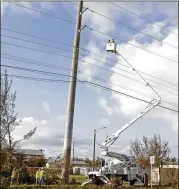  ?? ALAN DIAZ / ASSOCIATED PRESS ?? A crew checks power cables as utility crews work to reestablis­h power in the aftermath of Hurricane Irma on Thursday in Key West, Fla.