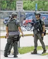  ?? Dario Lopez-mills / Associated Press ?? Police stand outside Robb Elementary after Tuesday’s shooting. The gunman used two rifles he bought on his birthday.