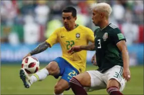  ?? AP PHOTO/FRANK AUGSTEIN ?? Brazil’s Fagner, left, and Mexico’s Carlos Salcedo challenge for the ball during the round of 16match between Brazil and Mexico at the 2018soccer World Cup in the Samara Arena, in Samara, Russia, Monday, July 2, 2018.