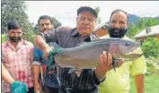  ??  ?? (From left) Chief trout farming project officer Mohammad Muzaffar Bazaz holds up a brooder, which is used to procure eggs and white milt, in Kokernag.
WASEEM ANDRABI/ HT