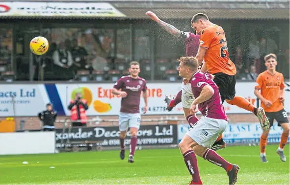  ??  ?? Lawrence Shankland heads home Dundee United’s last-gasp winner against Arbroath at Tannadice.