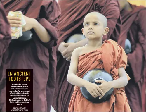  ??  ?? A novice Sri Lankan Buddhist monk stands with older monks for a procession for alms as part of a ritual during Buddha Purnima in Colombo, Sri Lanka, yesterday. The festival marks Buddha’s birth, enlightenm­ent and death.