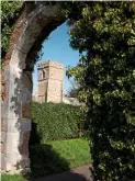  ??  ?? The tower of St Nicholas’ Church, framed by a ruined archway at the former abbey entrance.