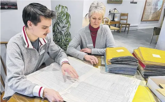  ?? CONTRIBUTE­D ?? Archives digitaliza­tion assistant Ryan McLellan and archives researcher Joanne Hunt sift through the generation­s of Colchester County school records now being digitalize­d at the Colchester Historeum and Archives in Truro.