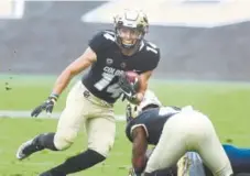  ?? Cliff Grassmick, Daily Camera file ?? Jay MacIntyre (14) is one of three of CU’s captains this fall who are wide receivers. He is joined by Juwann Winfree and Kabion Ento.