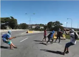  ??  ?? CARACAS: Demonstrat­ors fire a slingshot during clashes with security forces in Caracas, Venezuela. — AP