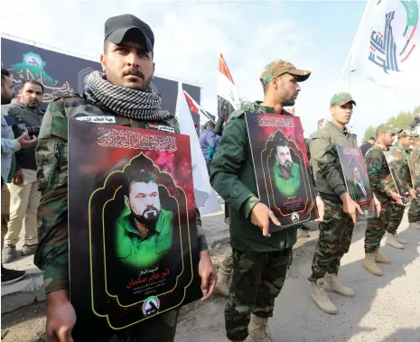  ?? EPA ?? Iraqi Shiite Popular Mobilisati­on Forces mourn their comrades who were killed in US air strikes, during a funeral in Baghdad