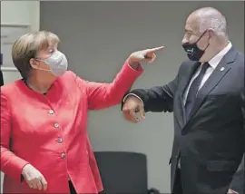  ?? Stephanie Lecocq Pool Photo ?? GERMAN CHANCELLOR Angela Merkel greets Bulgarian Prime Minister Boyko Borissov at the European Union summit that began Friday in Brussels.