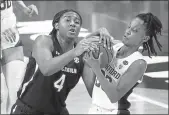  ?? MORRY GASH — THE ASSOCIATED PRESS ?? South Carolina forward Aliyah Boston, left, fights for possession with Stanford guard Kiana Williams during the first half of their women’s Final Four semifinal on Friday.