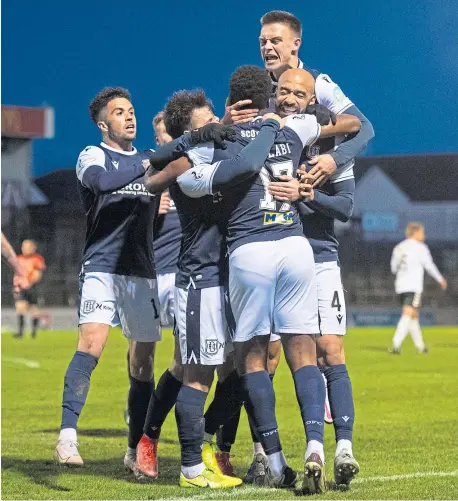  ??  ?? Max Anderson fires Dundee ahead, left, while Jonathan Afolabi is mobbed by team-mates after making it 2-0 at Somerset Park, above.