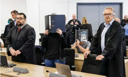  ?? Photograph: Jens Schlueter/AFP/Getty Images ?? The defendant Lina E with her lawyers in the courtroom in Dresden.