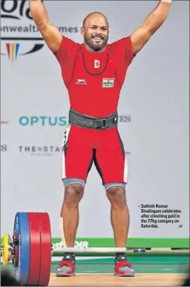  ??  ?? Sathish Kumar Sivalingam celebrates after clinching gold in the 77kg category on Saturday.