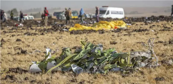  ?? AP FILE ?? STILL GROUNDED: Plane wreckage is scattered where the Ethiopian Airlines Boeing 737 Max 8 crashed in March 2019. When investigat­ors release a report on the crash they are expected to blame the jet’s automated flight control system and the pilots and their training.