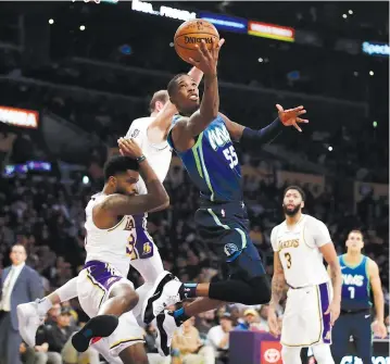  ?? AP Photo/Marcio Jose Sanchez ?? ■ Dallas Mavericks' Delon Wright (55) drives to the basket against the Los Angeles Lakers during the second half Sunday in Los Angeles.