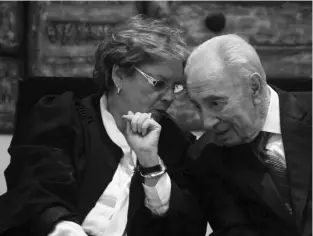  ?? (Marc Israel Sellem/the Jerusalem Post) ?? DORIT BEINISCH, the Supreme Court’s first woman president, confers with President Shimon Peres yesterday at the swearing-in ceremony.