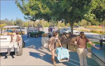  ?? Joseph Serna Los Angeles Times ?? L.A. ZOO STAFF move some small animals after a brush fire was spotted in nearby Griffith Park on Friday. Officials say smoke did not appear to have hurt the animals, but their health will continue to be monitored.