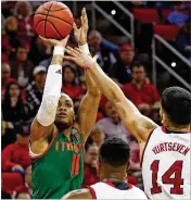  ?? KARL B.DEBLAKER / AP ?? Miami’s Bruce Brown Jr. (left) shoots the ball over North Carolina State’s Omer Yurtseven (right) and Torin Dorn. Brown scored 19 points in UM’s victory.