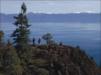  ?? FILE PHOTO ?? Visitors take in the view from Eagle Rock at Lake Tahoe in 2015. A new conservati­on law expected to be passed soon includes maintainin­g and enhancing public trails and beaches in the Lake Tahoe region.