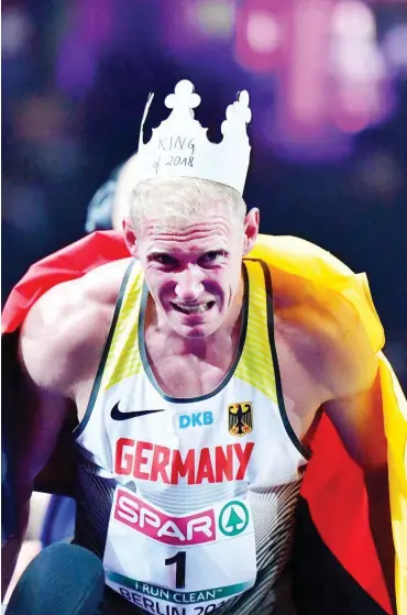  ?? Foto: AFP/Schwarz ?? Arthur Abele übermannte­n die Emotionen im Ziel. Die Krone des Athletenkö­nigs blieb Stunden auf dem Kopf.