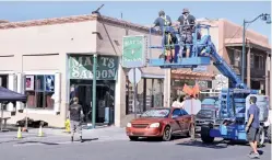  ?? CLYDE MUELLER/THE NEW MEXICAN ?? Evangelo’s at Galisteo and San Francisco streets is renamed ‘Matts Saloon’ as movie crews prepare the location Friday to film a scene for Granite Mountain.