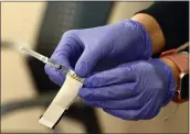  ?? SHERRY LAVARS — MARIN INDEPENDEN­T JOURNAL ?? A nurse handles a dose of the Pfizer coronaviru­s vaccine on Jan. 7at Novato Community Hospital. The county is following state guidelines on prioritizi­ng vaccine recipients.