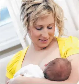  ??  ?? A young mother breastfeed­s her new born baby boy at home