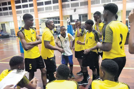  ?? FILE ?? Jamaica Under 19 Men’s Volleyball coach Steve Davis (second left, standing) gives his team instructio­ns during the Caribbean Zonal Volleyball Associatio­n Youth Tournament at the GC Foster College in 2019.