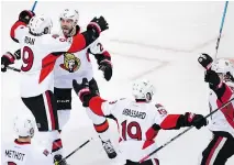  ?? CHARLES KRUPA/THE ASSOCIATED PRESS ?? The Senators’ Bobby Ryan, left, and teammates celebrate his overtime goal against the Bruins on Monday.