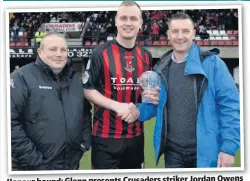  ??  ?? Honour bound: Glenn presents Crusaders striker Jordan Owens
with an award to mark the breaking of his club goal record