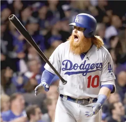  ??  ?? Justin Turner reacts to his home run in the eighth inning Wednesday night that cut the Dodgers’ deficit to one. | JAMIE SQUIRE/ GETTY IMAGES