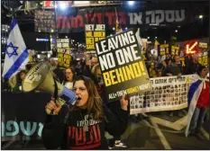  ?? ARIEL SCHALIT — THE ASSOCIATED PRESS ?? Friends and relatives of the Israeli hostages held in the Gaza Strip by Hamas attend a rally calling for their release Saturday in Tel Aviv, Israel. With each passing day, the relatives of the hostages face a deepening despair.