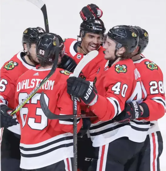  ?? NAM Y. HUH/AP ?? Blackhawks forward Andreas Martinsen (29) celebrates with teammates after scoring the first goal in the first period Wednesday night against the Penguins.