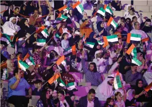  ??  ?? People holding UAE flags during the celebratio­ns on Al Majaz beachfront in Sharjah.