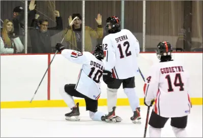  ?? KYLE FRANKO — TRENTONIAN PHOTO ?? Robbinsvil­le/Allentown’s Zach Duggan (10) and JP Sferra (12) celebrate Duggan’s goal against Hopewell Valley/ Montgomery during a Mercer County Tournament ice hockey semifinal game at Mercer Rink in West Windsor.