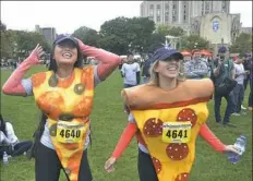  ?? Larry Roberts/Post-Gazette ?? Irene Lee, left, and Maddie Mesard dance to music played at the end of last year’s Donut Dash at Schenley Plaza in Oakland. Both are Kappa Alpha Theta sorority members.