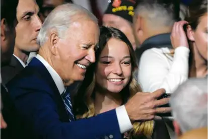  ?? GEORGE FREY/GETTY IMAGES ?? President Biden took a selfie with Emma Kate Cox, daughter of Utah Governor Spencer Cox, at the George E. Wahlen Department of Veterans Affairs Medical Center in Salt Lake City.