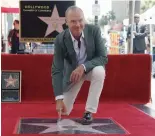  ?? — AP ?? Actor Michael Keaton poses at a ceremony awarding him with a star on the Hollywood Walk of Fame in Los Angeles on Thursday.