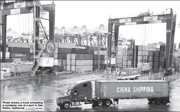  ?? REUTERS ?? Photo shows a truck unloading a container van at a port in San Pedro, California.