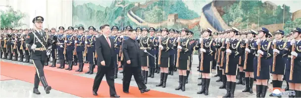  ?? — Reuters photo ?? Xi (front, centre) holds a welcoming ceremony for Kim before their talks at the Great Hall of the People in Beijing, China, in this photo released by North Korea’s Korean Central News Agency (KCNA).