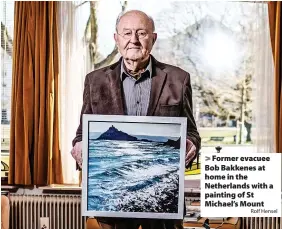  ?? Rolf Hensel ?? Former evacuee Bob Bakkenes at home in the Netherland­s with a painting of St Michael’s Mount