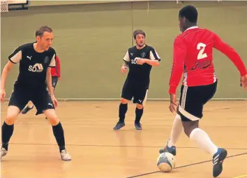  ??  ?? Shaun Henderson (Montrose), on left, gets set to challenge Dundee University player Anthony Darlington in a Scottish Futsal League match. The University won 3-2.