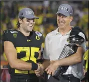  ??  ?? HAPPIER DAYS
Oregon safety Brady Breeze and head coach Mario Cristobal celebrates after their win against Wisconsin in the Rose Bowl on Jan. 1 in Pasadena.