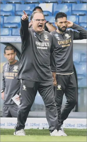  ?? PICTURE: YPN ?? MARCHING ON TOGETHER?: Leeds United coach Marcelo Bielsa says he wants to enjoy the club’s success – rather than discuss his future. His assistant Carlos Corberan, right, is set to join Huddersfie­ld Town.